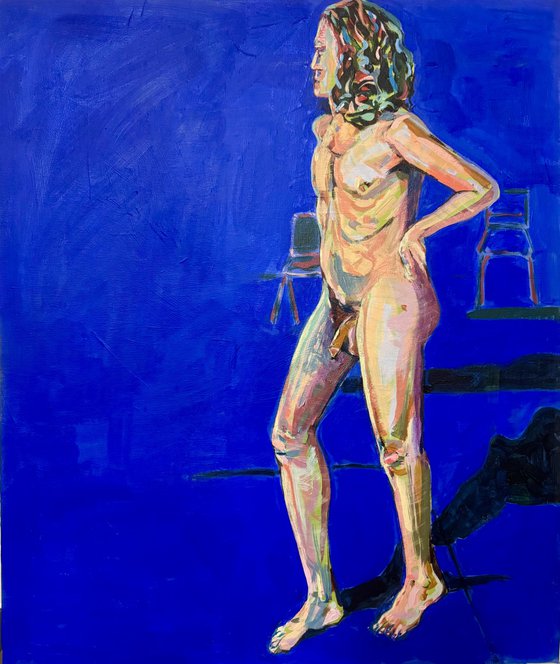 Young nude man in blue room