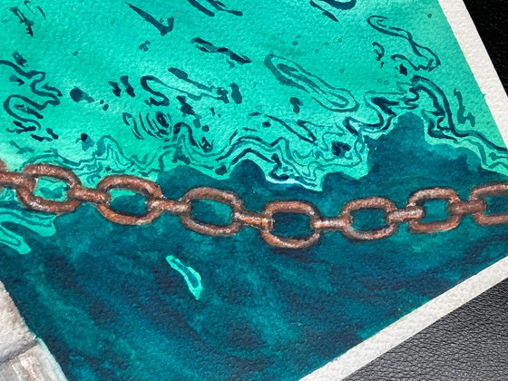 Emerald sea and rusty chain
