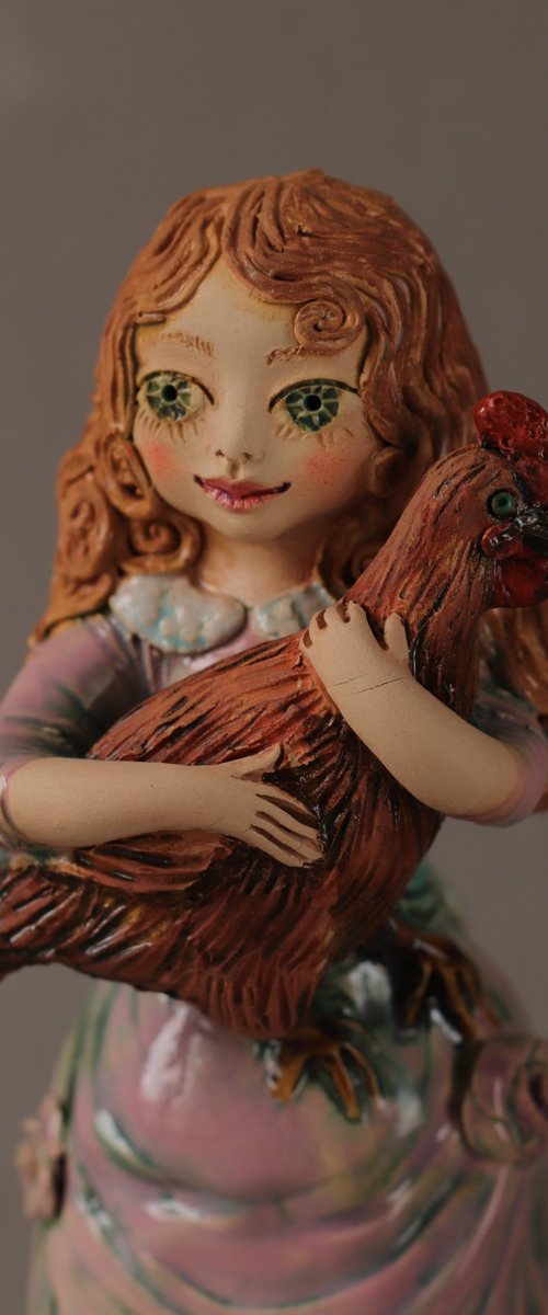 Vintage dressed girl holding a chicken. by Elya Yalonetski