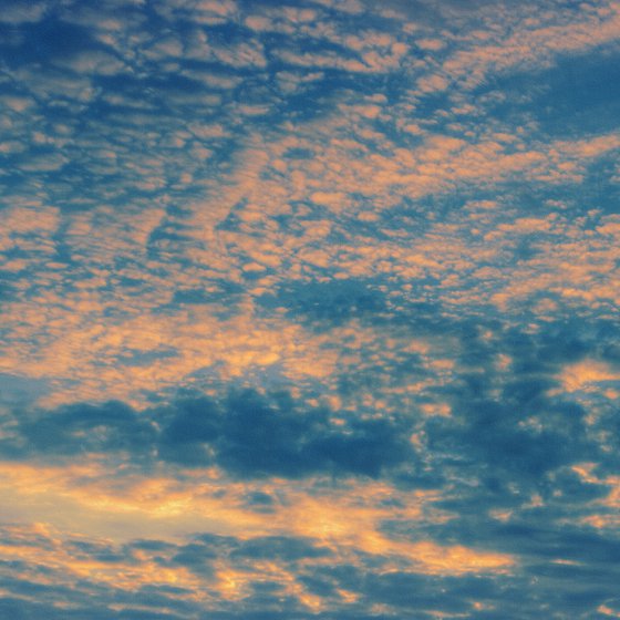 Flying clouds over the setting sun.