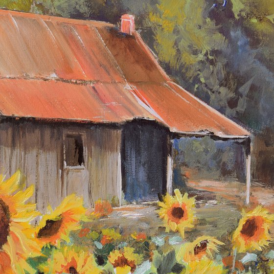 Old cabin with sunflower yard