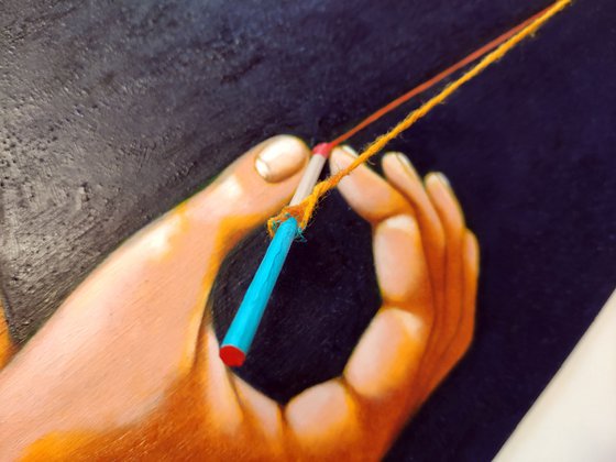 Two hands holding a thread
