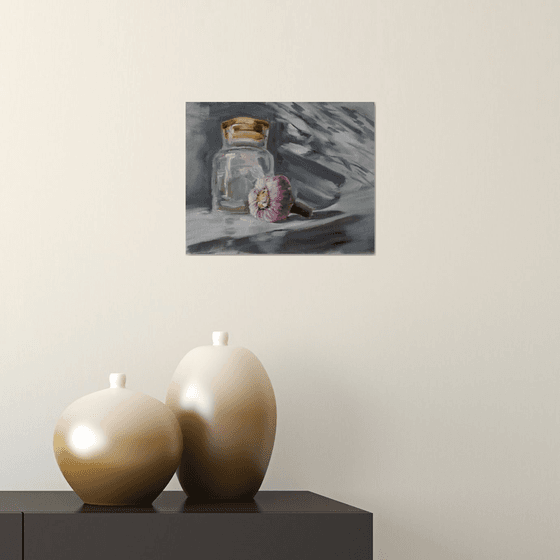 Glass jar and garlic. Still life.