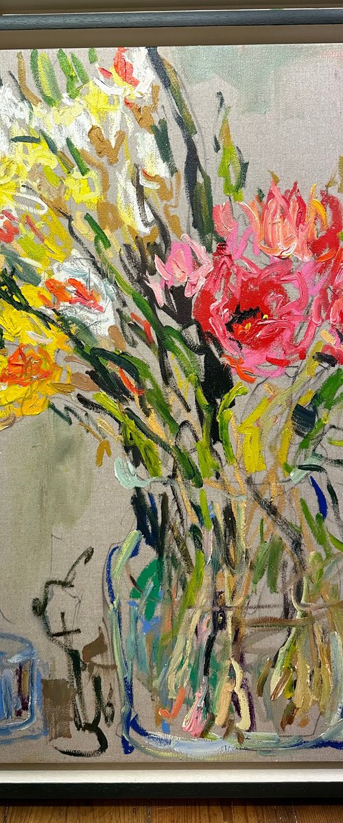 Tulips and daffodils in a glass vase by Lilia Orlova-Holmes