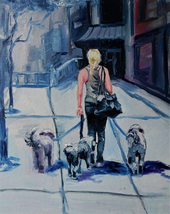 Woman walking with the dogs. Cityscape.