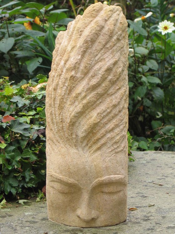 Stillness; face of a woman (weathered stone carving)