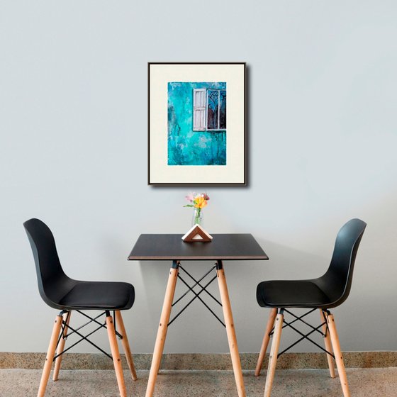 A window in a turquoise wall