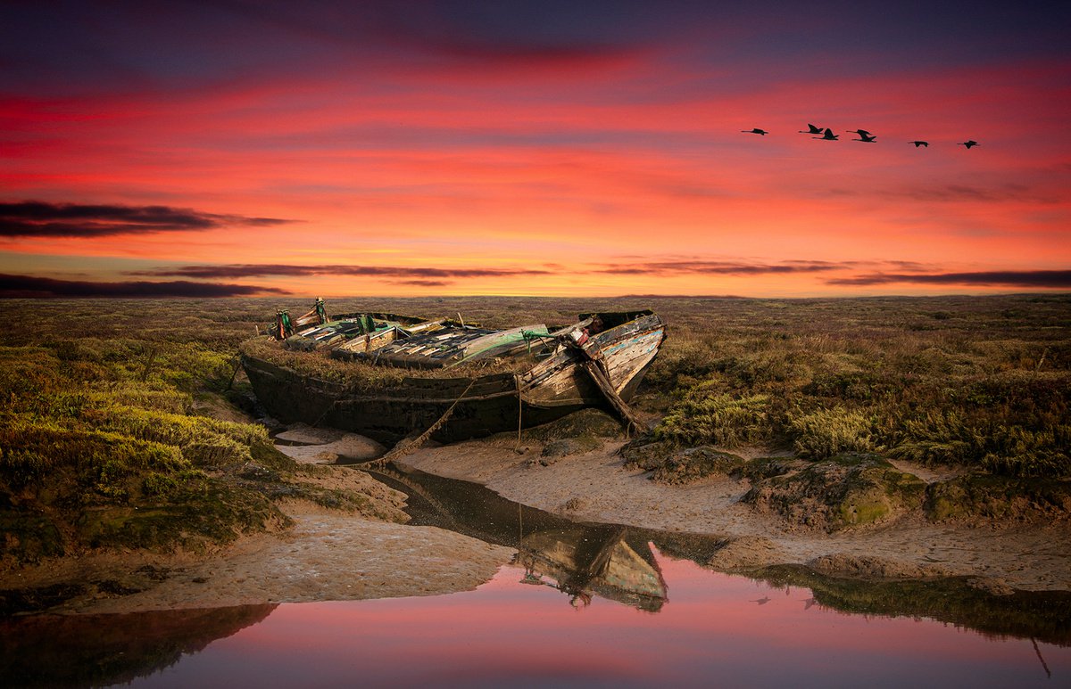 derelict barge at sunset by DAVID SLADE