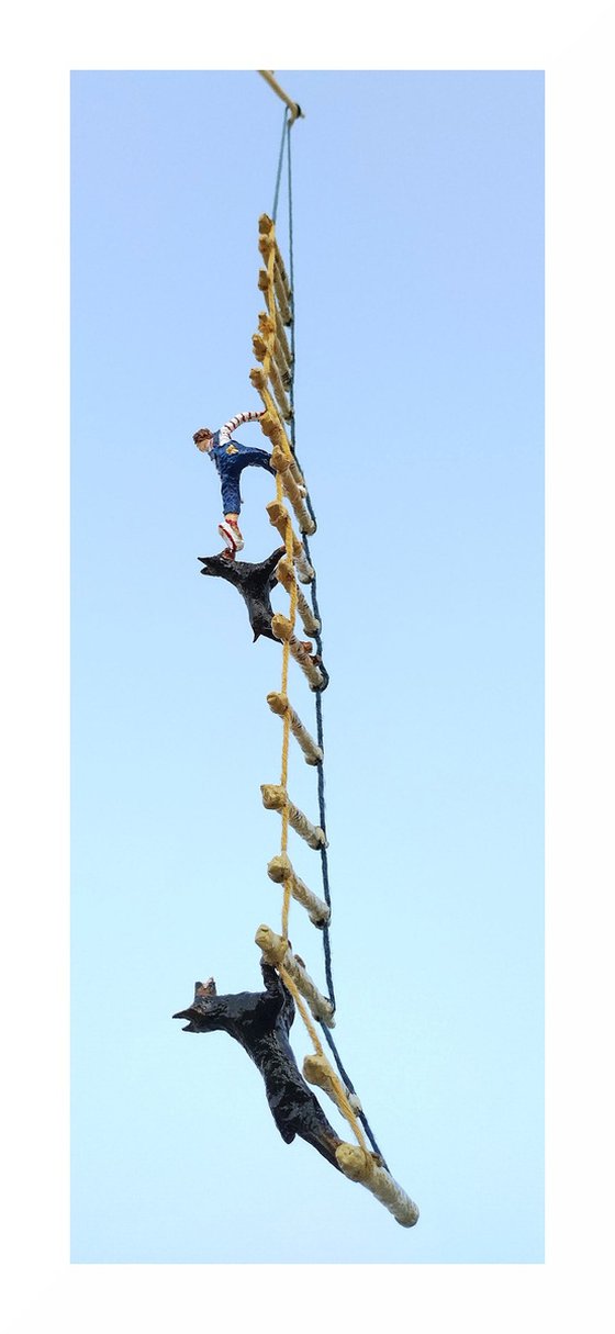 Two Dobermans and the figure on the ladder