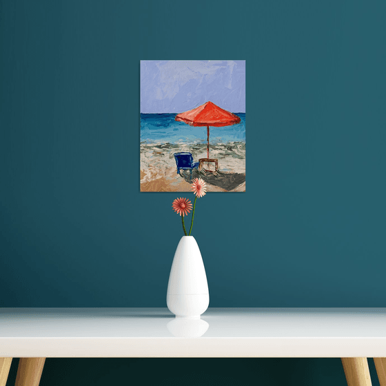 Red parasol on the beach.