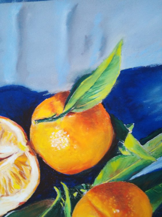 Three tangerines on blue