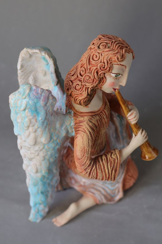 Sitting Angel with a flute. Ceramic OOAK sculpture.