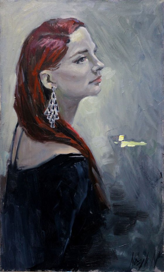 A portrait of a young woman with red hair.