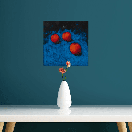 modern still life of peaches with blue background