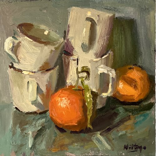 Stacked cups and oranges by Nithya Swaminathan