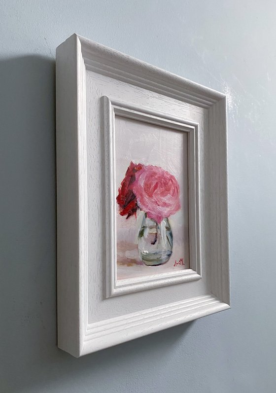 Pink and red Roses in a glass vase.