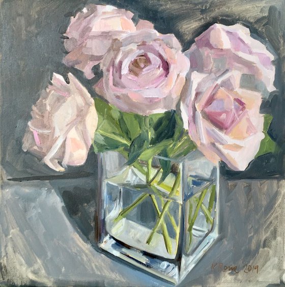 Pale pink roses in square glass vase