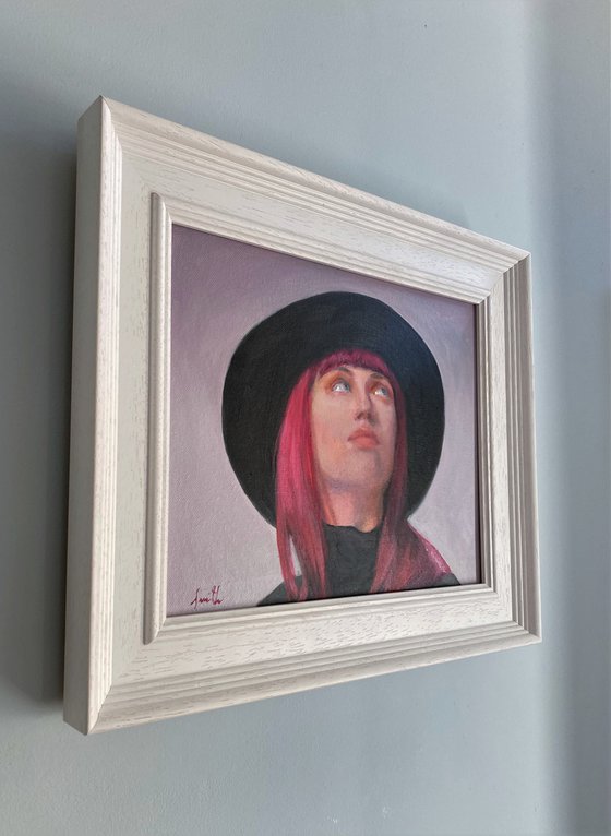 Contemporary portrait of a young woman with a hat.