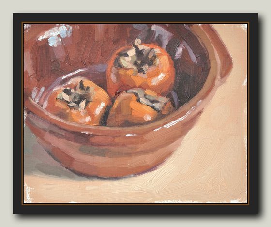 Persimmons in an earthenware dish