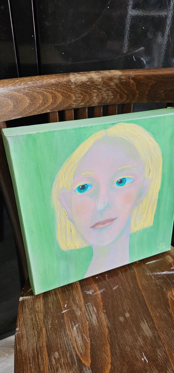 Young and blond soft green woman portrait