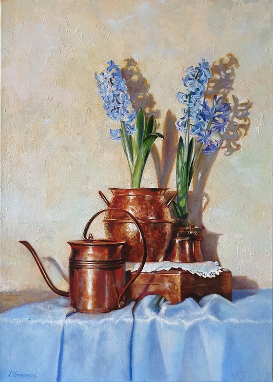 "Blue hyacinths in copper jugs."