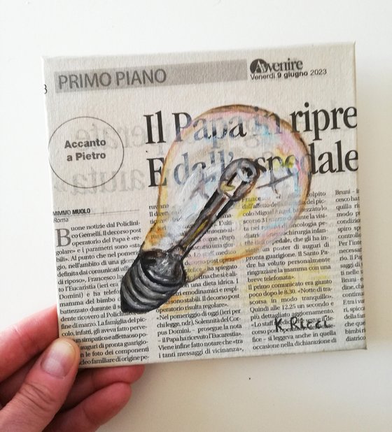 Light Bulb on Newspaper