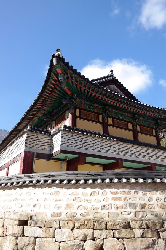 Painted Eaves Against a Blue Autumn Sky