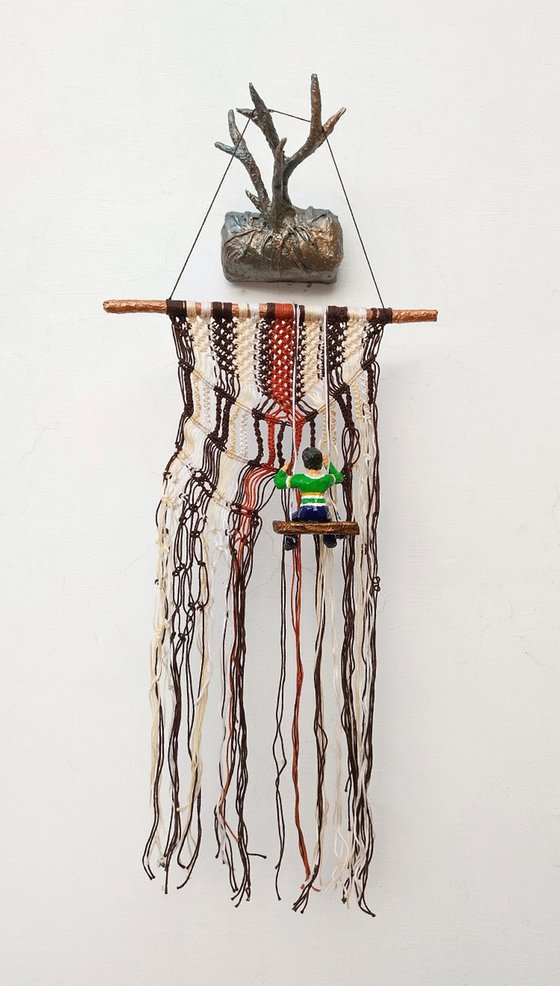 Boy on the macrame wall hanging