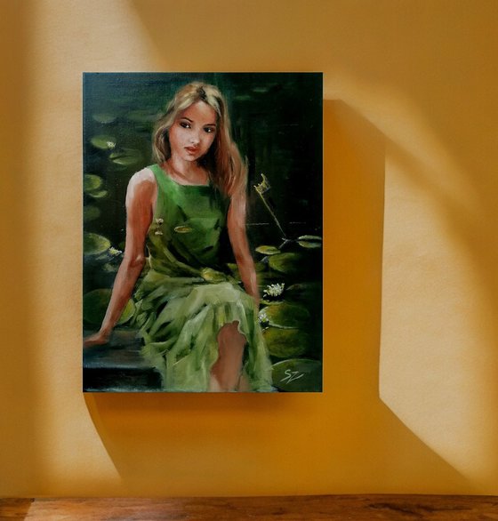 Girl sitting  by the pond