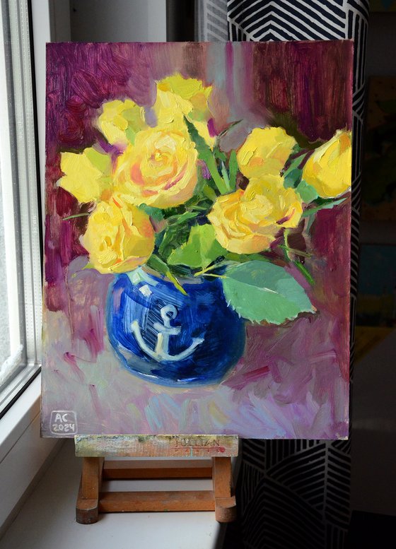 Yellow tulips in a blue vase on a purple background