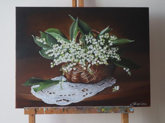 Lilies of the valley in rustic basket