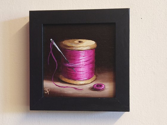 Little pink  cotton reel with button still life