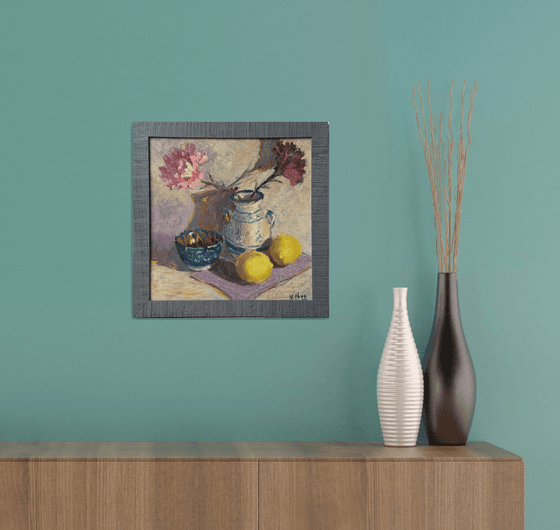 Lemons and flowers with a vase