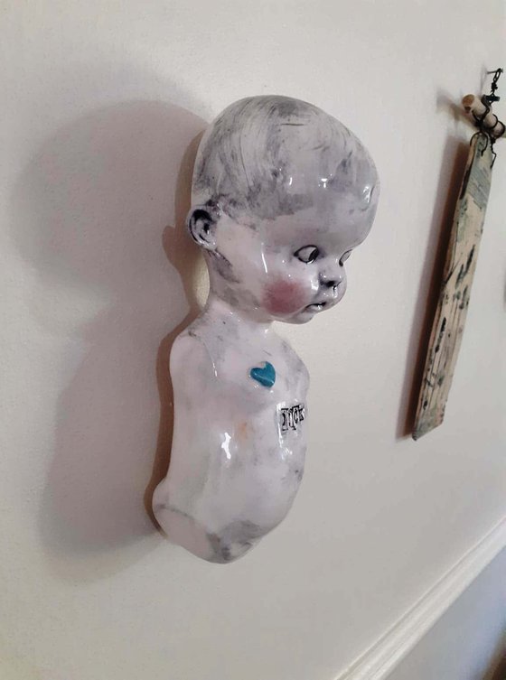 Ceramic baby doll sculpture