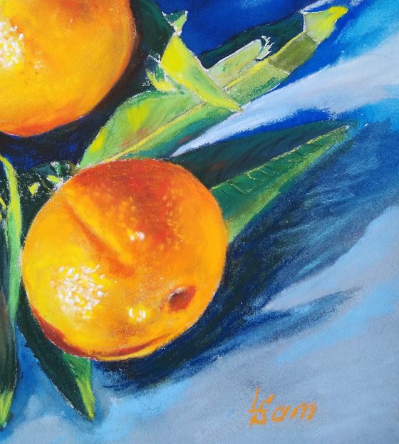 Three tangerines on blue