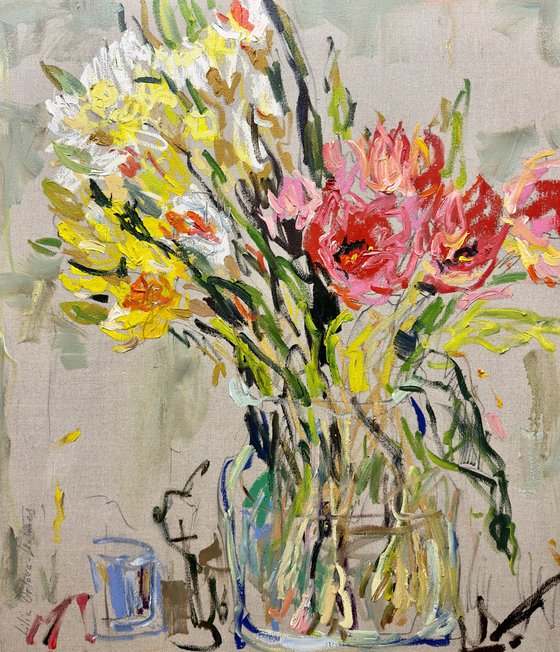 Tulips and daffodils in a glass vase