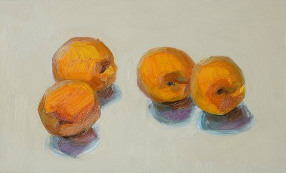 four apricots on white