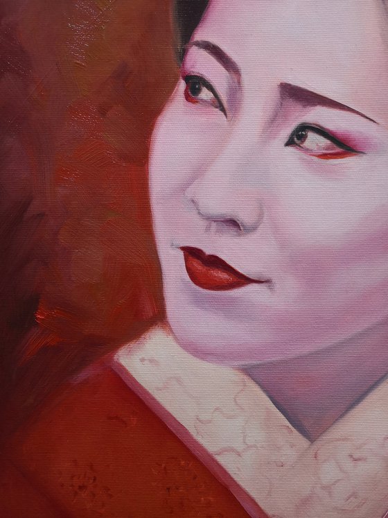 Portrait of Geisha in kimono in red colors