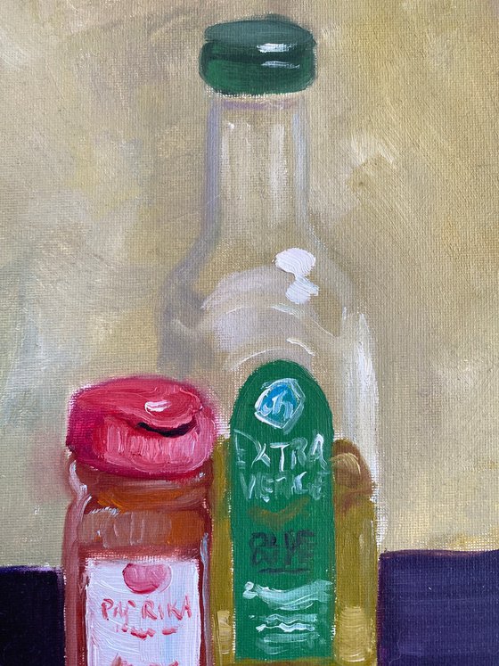 Still life with a bottle of olive oil and paprika