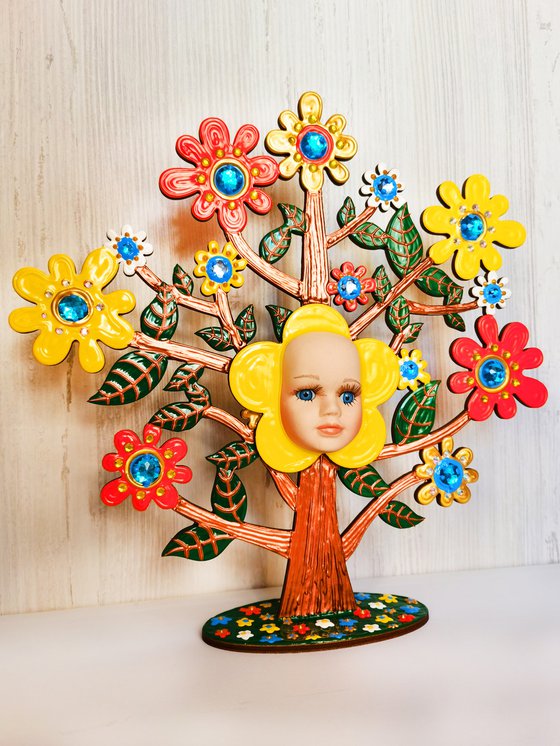 Baby tree with flowers. Fairytale fantasy tree, positive colorful sculpture