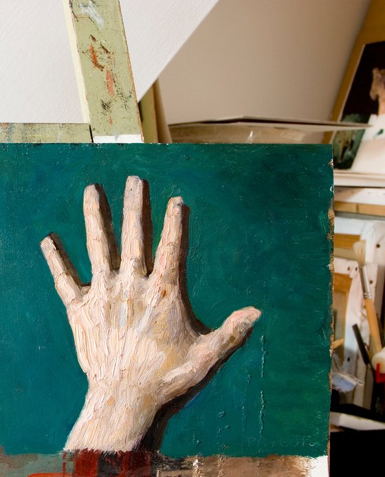 rough expressionist hand on green background