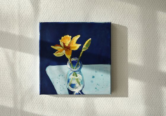 Daffodils in a blue bottle