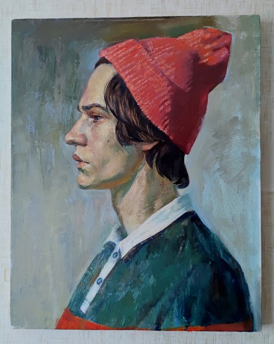 Portrait of a young man in a pink hat