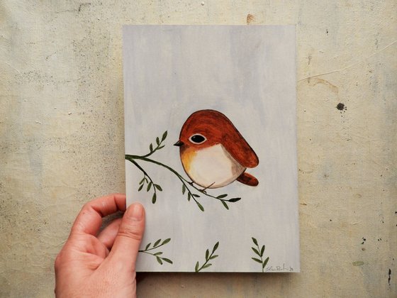 The small bird in burnt Sienna color