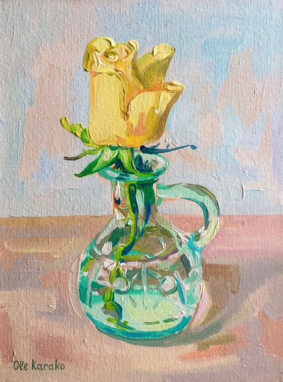 Yellow rose in a glass vase on a light background.