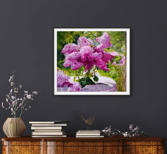 Lilac bouquet in a glass vase in the garden still life