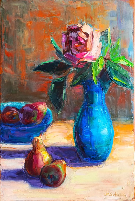 Red rose in a blue vase