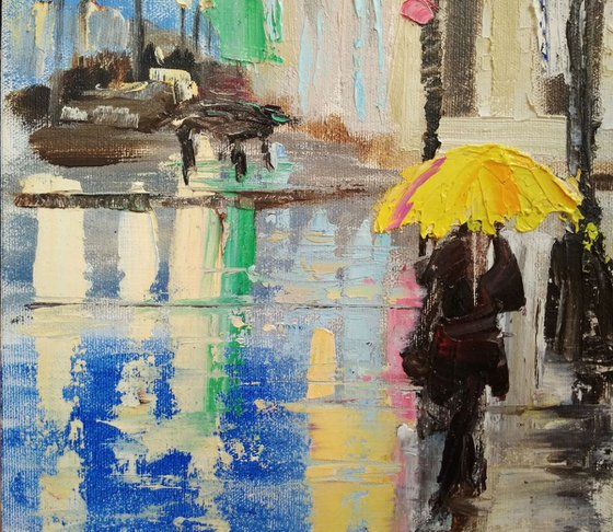 Rainy evening in the City and woman with yellow umbrella