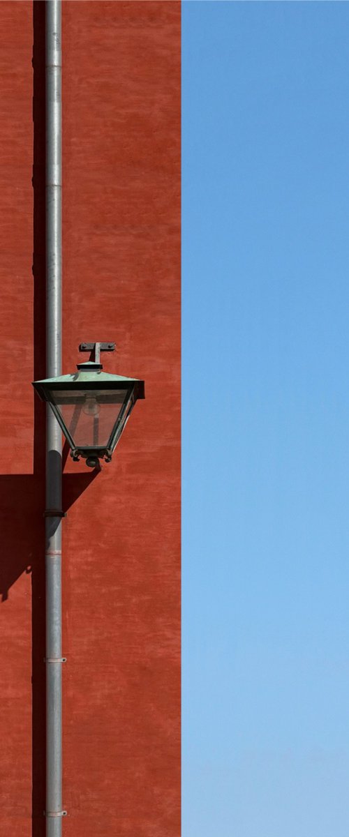 Red wall with a lamp by Marcus Cederberg