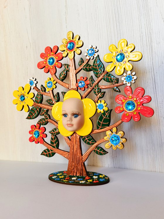 Baby tree with flowers. Fairytale fantasy tree, positive colorful sculpture